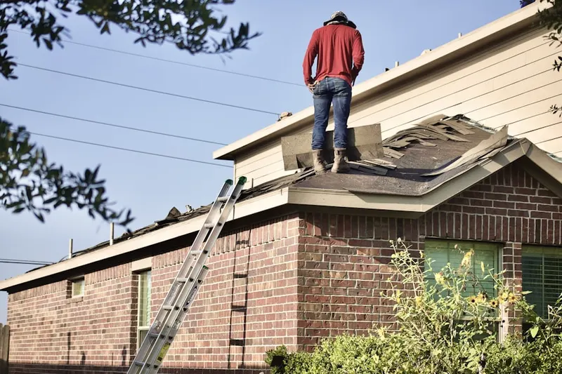 Professional roofer working on a residential roof in Metcalf